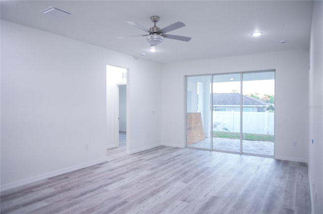 empty room featuring ceiling fan and light hardwood / wood-style flooring