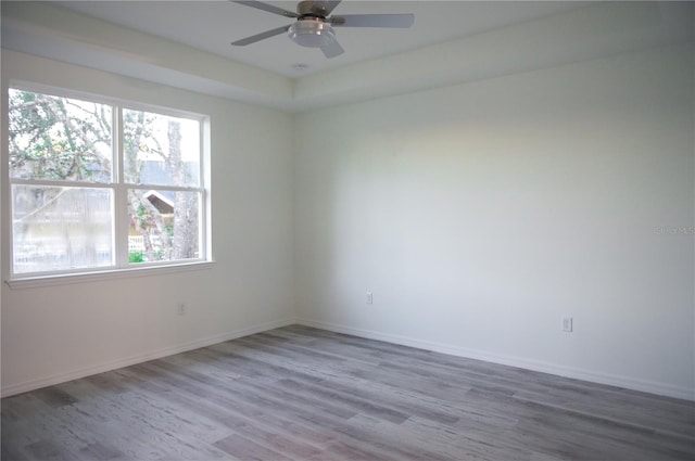 unfurnished room with hardwood / wood-style flooring and ceiling fan