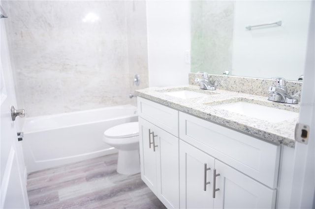 full bathroom featuring hardwood / wood-style flooring, vanity, toilet, and washtub / shower combination