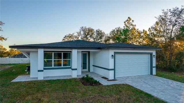 view of front of house featuring a front yard and a garage