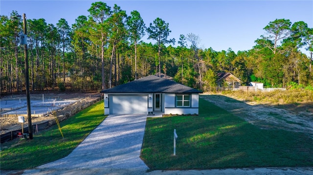 view of front of home with a garage and a front lawn