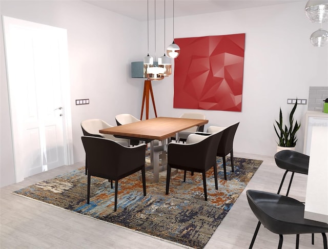 dining space with a chandelier and hardwood / wood-style flooring