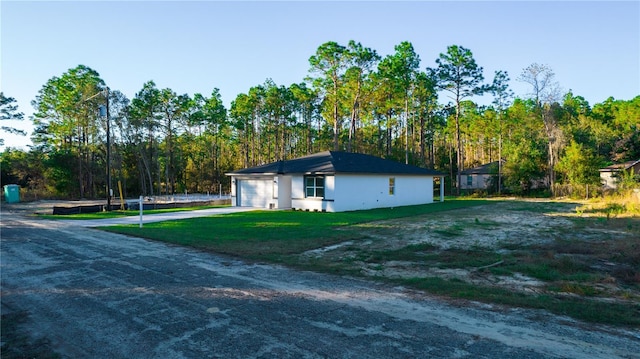 view of property exterior featuring a lawn and a garage