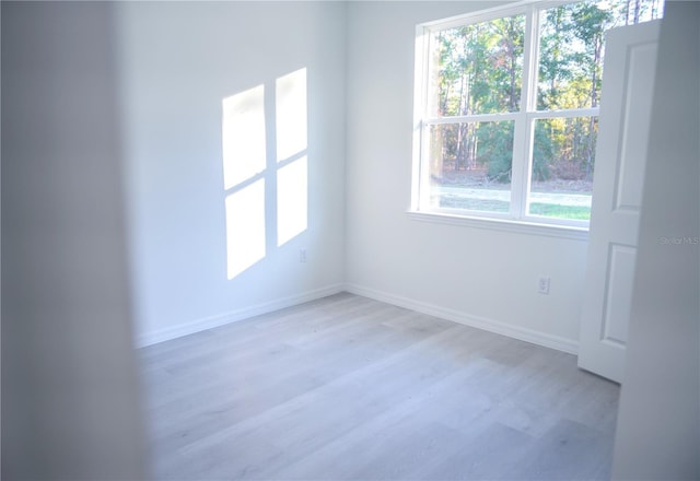 unfurnished room with light hardwood / wood-style flooring