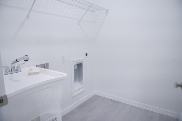 laundry area featuring hookup for an electric dryer, hardwood / wood-style flooring, sink, and hookup for a washing machine