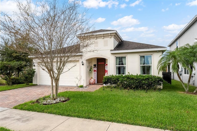 view of front of property featuring a front yard and a garage