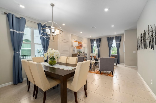 dining room with a chandelier, light tile patterned floors, and plenty of natural light