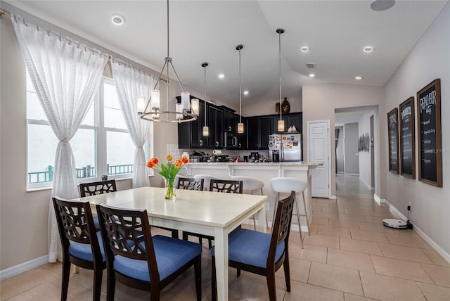 dining room featuring light tile patterned floors, a chandelier, and lofted ceiling