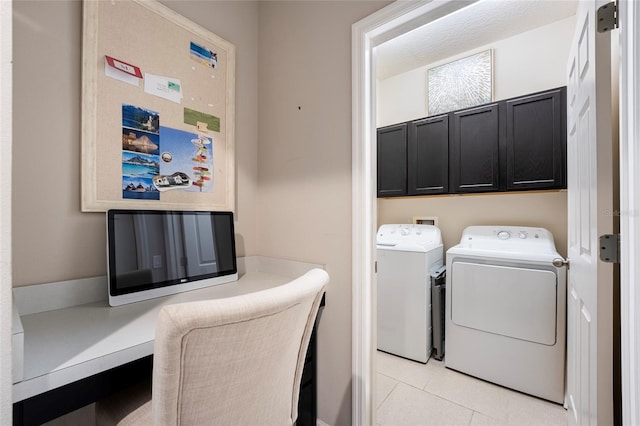 laundry area featuring cabinets, light tile patterned floors, and separate washer and dryer