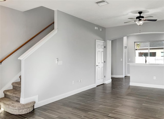 unfurnished living room with dark hardwood / wood-style flooring, lofted ceiling, and ceiling fan