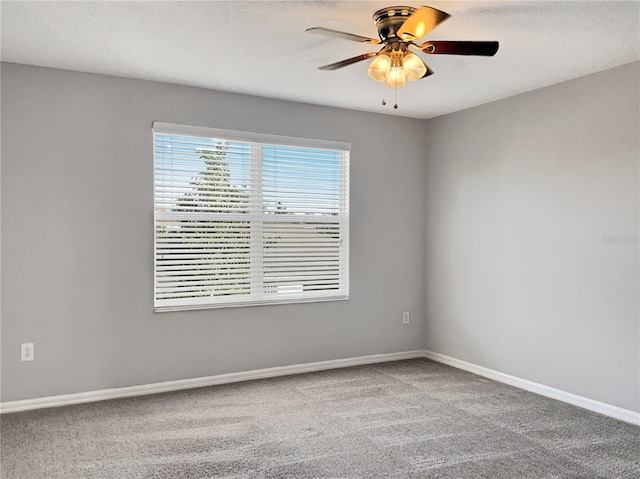 spare room featuring carpet and ceiling fan