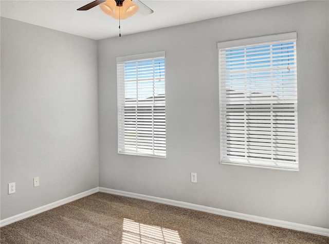 carpeted empty room featuring ceiling fan