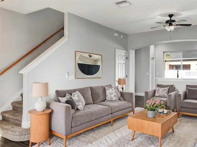 living room with hardwood / wood-style floors, lofted ceiling, and ceiling fan