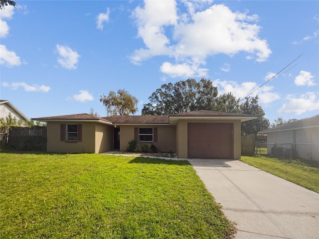 view of front of property featuring a garage and a front yard