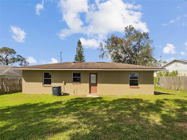 rear view of property with a yard and cooling unit