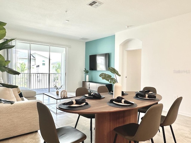 dining area featuring a textured ceiling