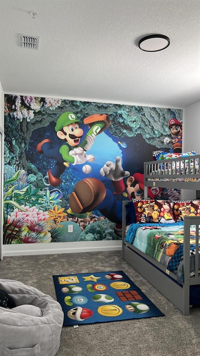 bedroom featuring a textured ceiling and carpet floors