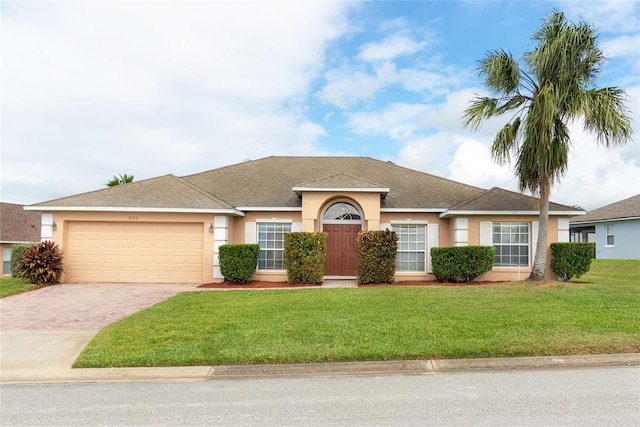 ranch-style home featuring a front lawn and a garage