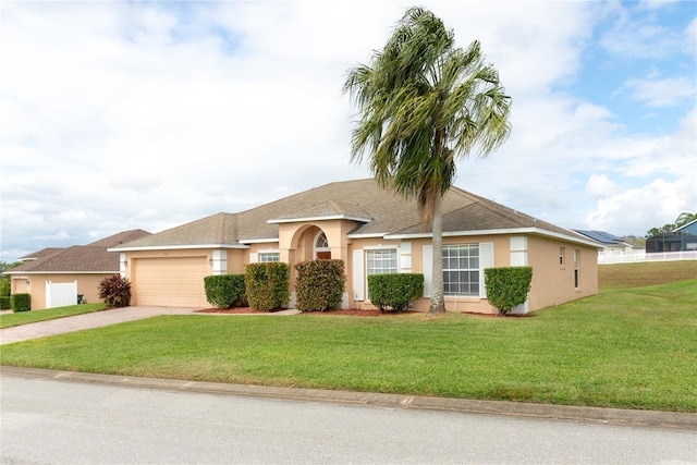 view of front of home featuring a garage and a front lawn