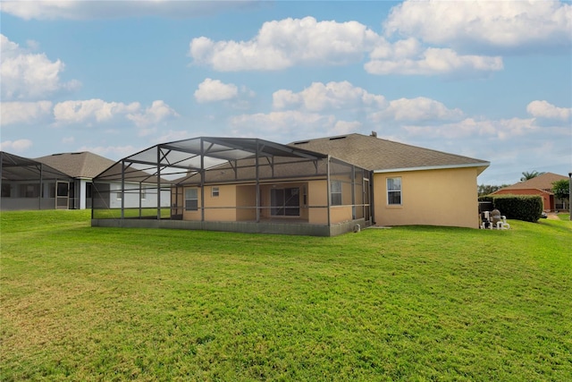 back of house featuring a lanai and a lawn