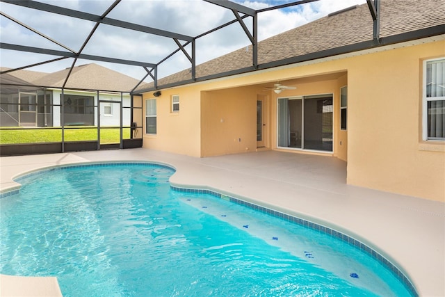 view of pool featuring glass enclosure, ceiling fan, and a patio area