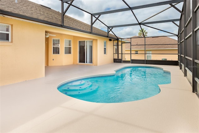 view of swimming pool featuring a lanai, ceiling fan, and a patio