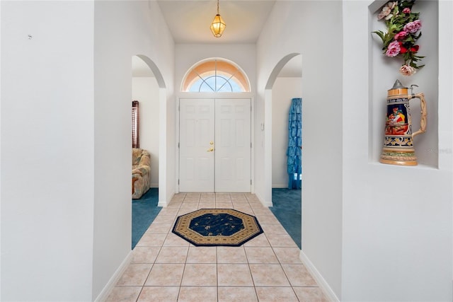 entryway with light tile patterned flooring