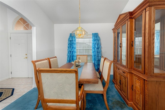 dining room with light tile patterned flooring and an inviting chandelier