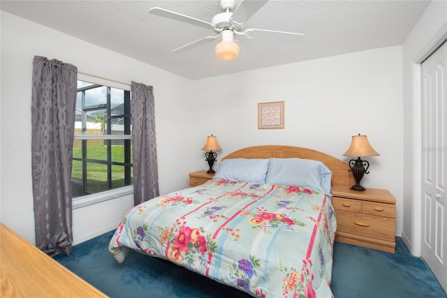 carpeted bedroom with ceiling fan, a textured ceiling, and a closet