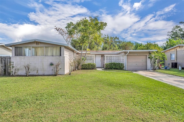 single story home with a garage and a front yard