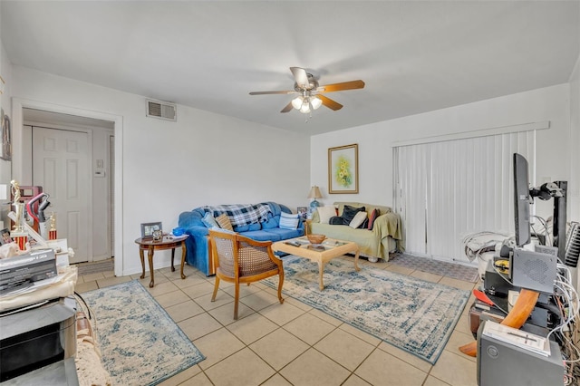 living room featuring light tile patterned flooring and ceiling fan