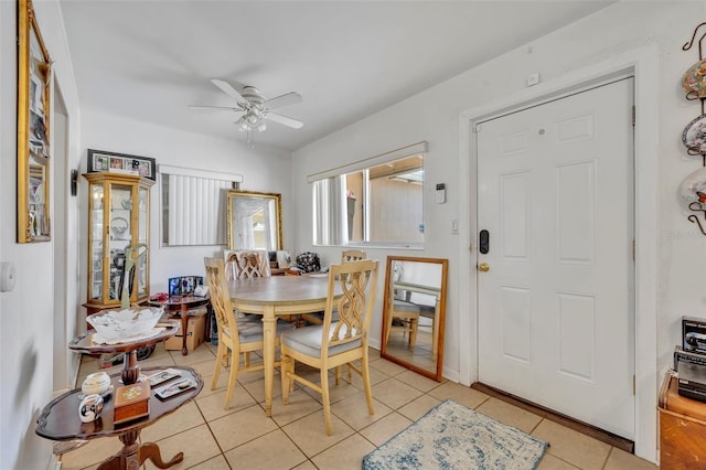 dining area with light tile patterned floors and ceiling fan