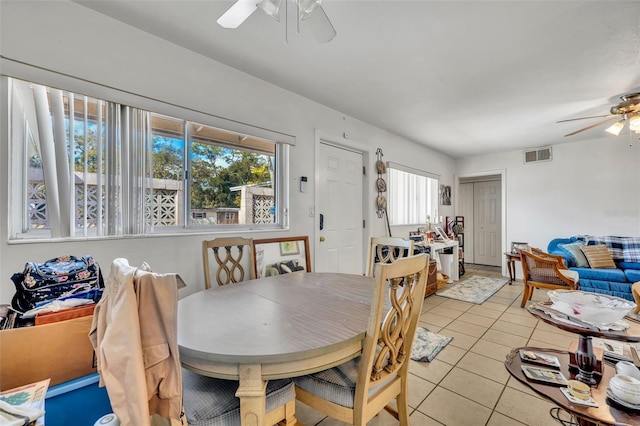 dining space with light tile patterned floors and ceiling fan