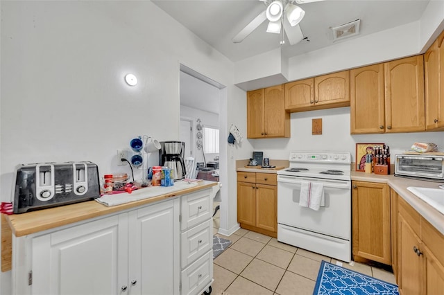 kitchen featuring white electric stove, ceiling fan, and light tile patterned flooring