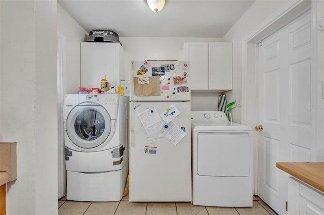 laundry room featuring cabinets, washer and dryer, and light tile patterned floors