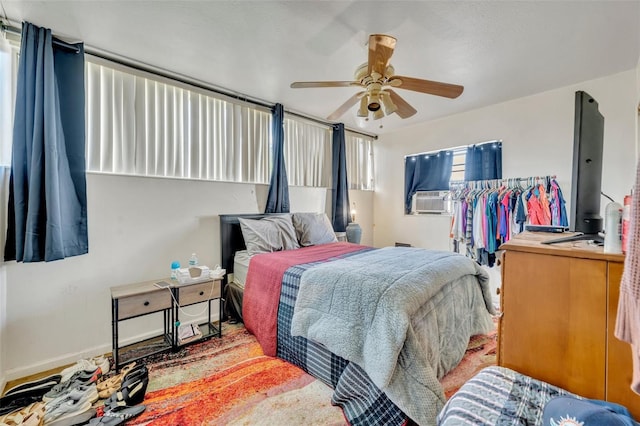 bedroom featuring cooling unit and ceiling fan