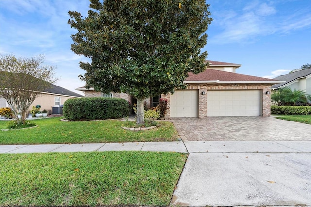 2626 Raccoon Run Ln, Orlando, FL 32837 - obstructed view of property with driveway, brick siding, a garage, and a front yard