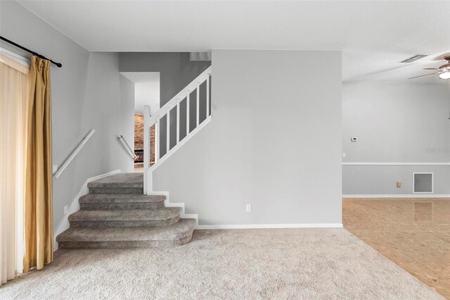 2626 Raccoon Run Ln, Orlando, FL 32837 - stairs featuring carpet floors, a ceiling fan, and baseboards