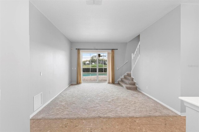 2626 Raccoon Run Ln, Orlando, FL 32837 - foyer entrance with light carpet, stairs, and baseboards