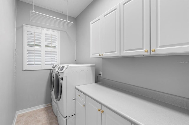 2626 Raccoon Run Ln, Orlando, FL 32837 - laundry area featuring separate washer and dryer, cabinet space, baseboards, and attic access