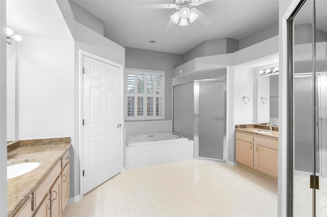 2626 Raccoon Run Ln, Orlando, FL 32837 - bathroom with two vanities, a ceiling fan, a stall shower, a bath, and tile patterned floors