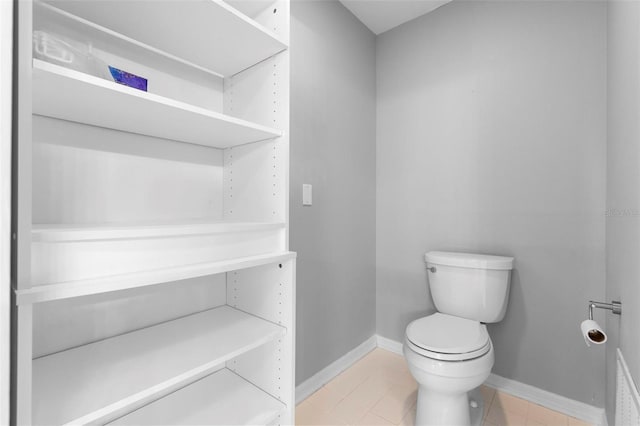 2626 Raccoon Run Ln, Orlando, FL 32837 - bathroom with toilet, baseboards, and tile patterned floors