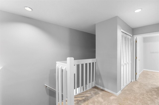 2626 Raccoon Run Ln, Orlando, FL 32837 - corridor featuring an upstairs landing, carpet floors, baseboards, and recessed lighting