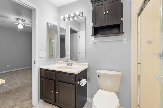 2626 Raccoon Run Ln, Orlando, FL 32837 - bathroom with tiled shower, toilet, ceiling fan, vanity, and baseboards