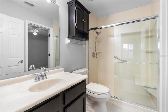 2626 Raccoon Run Ln, Orlando, FL 32837 - full bathroom with toilet, a shower stall, vanity, tile patterned flooring, and ceiling fan