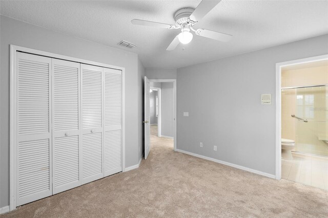 2626 Raccoon Run Ln, Orlando, FL 32837 - unfurnished bedroom featuring carpet flooring, a closet, baseboards, and a textured ceiling