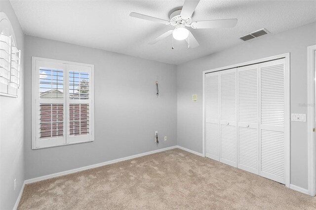 2626 Raccoon Run Ln, Orlando, FL 32837 - unfurnished bedroom featuring carpet, a closet, baseboards, and a ceiling fan
