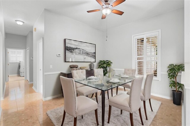 2626 Raccoon Run Ln, Orlando, FL 32837 - dining area featuring washer / dryer, ceiling fan, light tile patterned floors, and baseboards