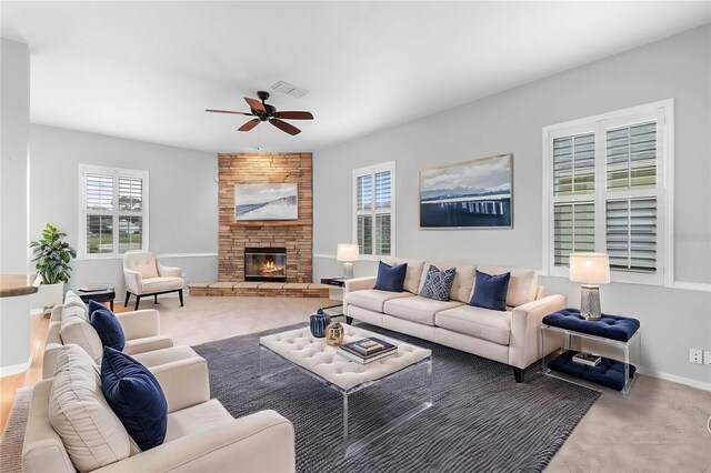 2626 Raccoon Run Ln, Orlando, FL 32837 - carpeted living room featuring a ceiling fan, a stone fireplace, and baseboards