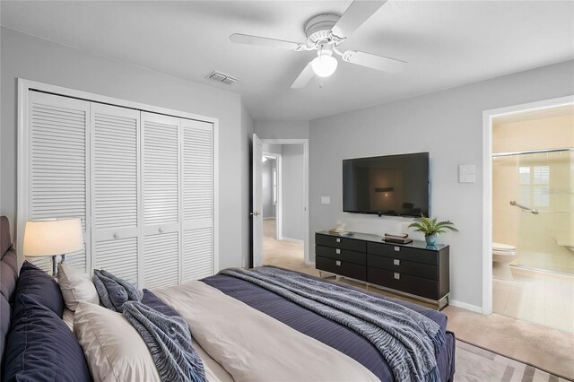 2626 Raccoon Run Ln, Orlando, FL 32837 - bedroom with carpet, a closet, a ceiling fan, baseboards, and ensuite bathroom